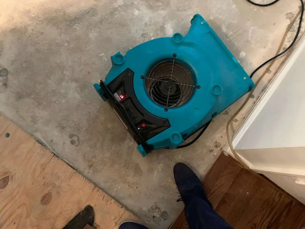 Air mover drying subfloor during Leak Detection & Repair in Country Club